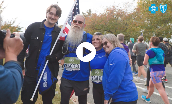 Runners posing together with an American flag after a race.
