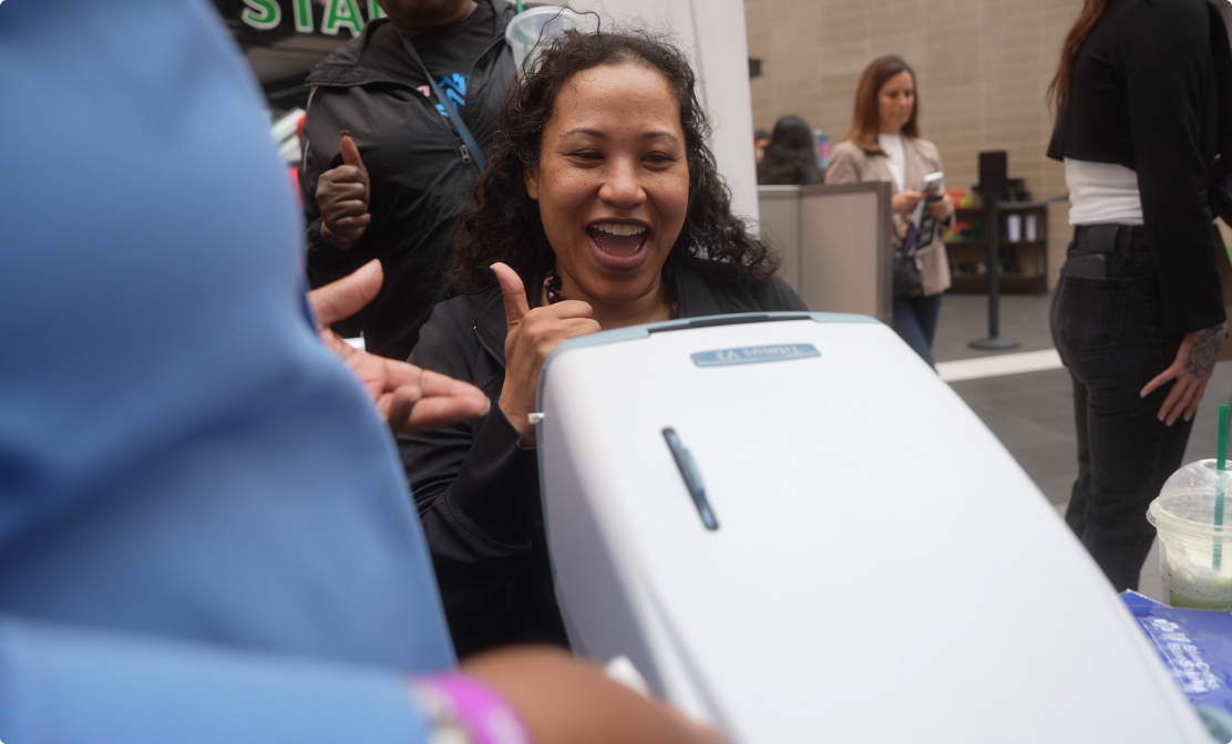 Happy woman giving thumbs up at health event