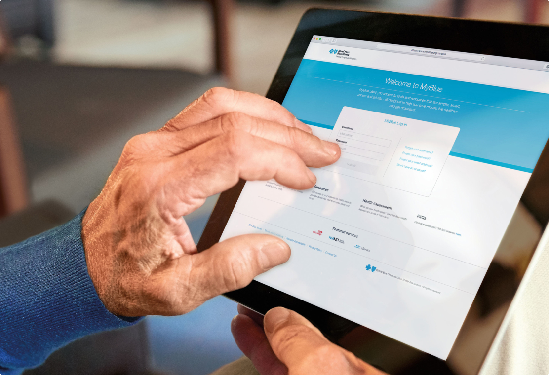Male hands holding a tablet device showing the MyBlue sign up screen