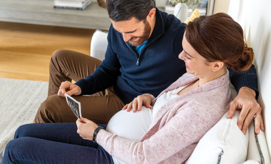 Man and expectant mother looking at a sonogram