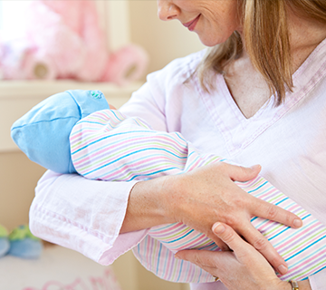 woman holding infant in arms